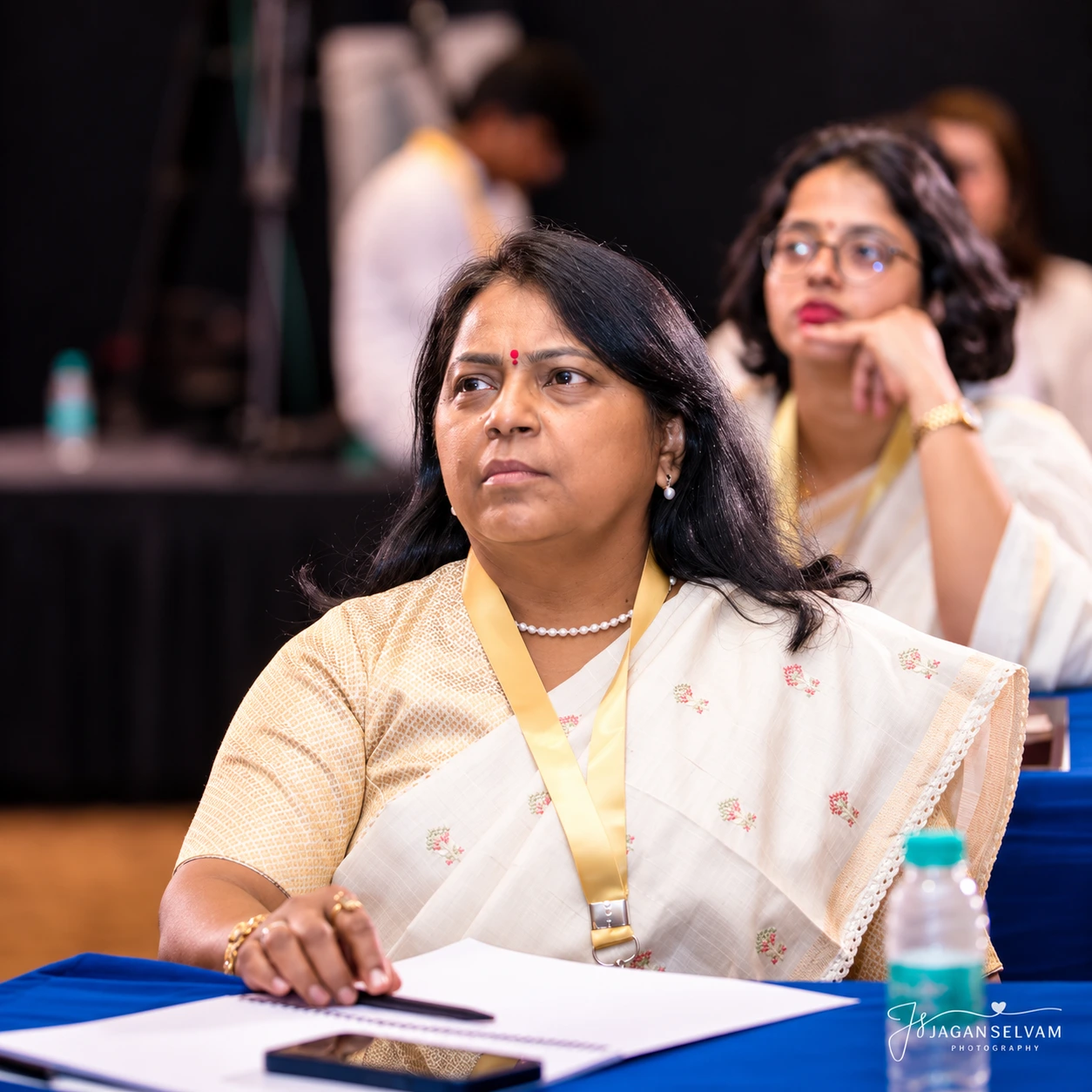 Thoughtful Conference Attendee at Table